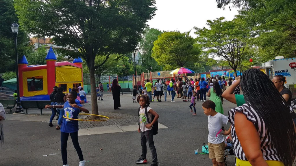 Community event hosted by United Parks As One featuring families, food trucks, and youth activities in a local Newark park