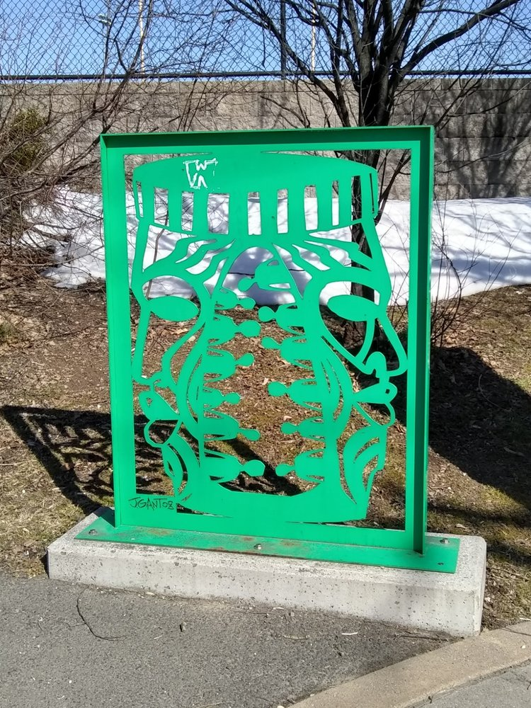 Green steel sculpture of an African drum representing the origins of African-American music, located at the entrance of Nat Turner Park on Muhammad Ali Avenue.