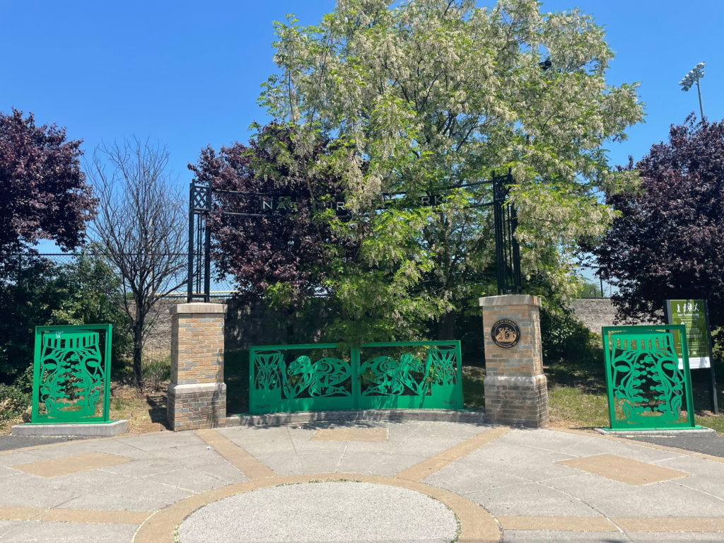 Green metal sphinx sculptures and African drums at the entrance to Nat Turner Park on Muhammad Ali Avenue in Newark, NJ.