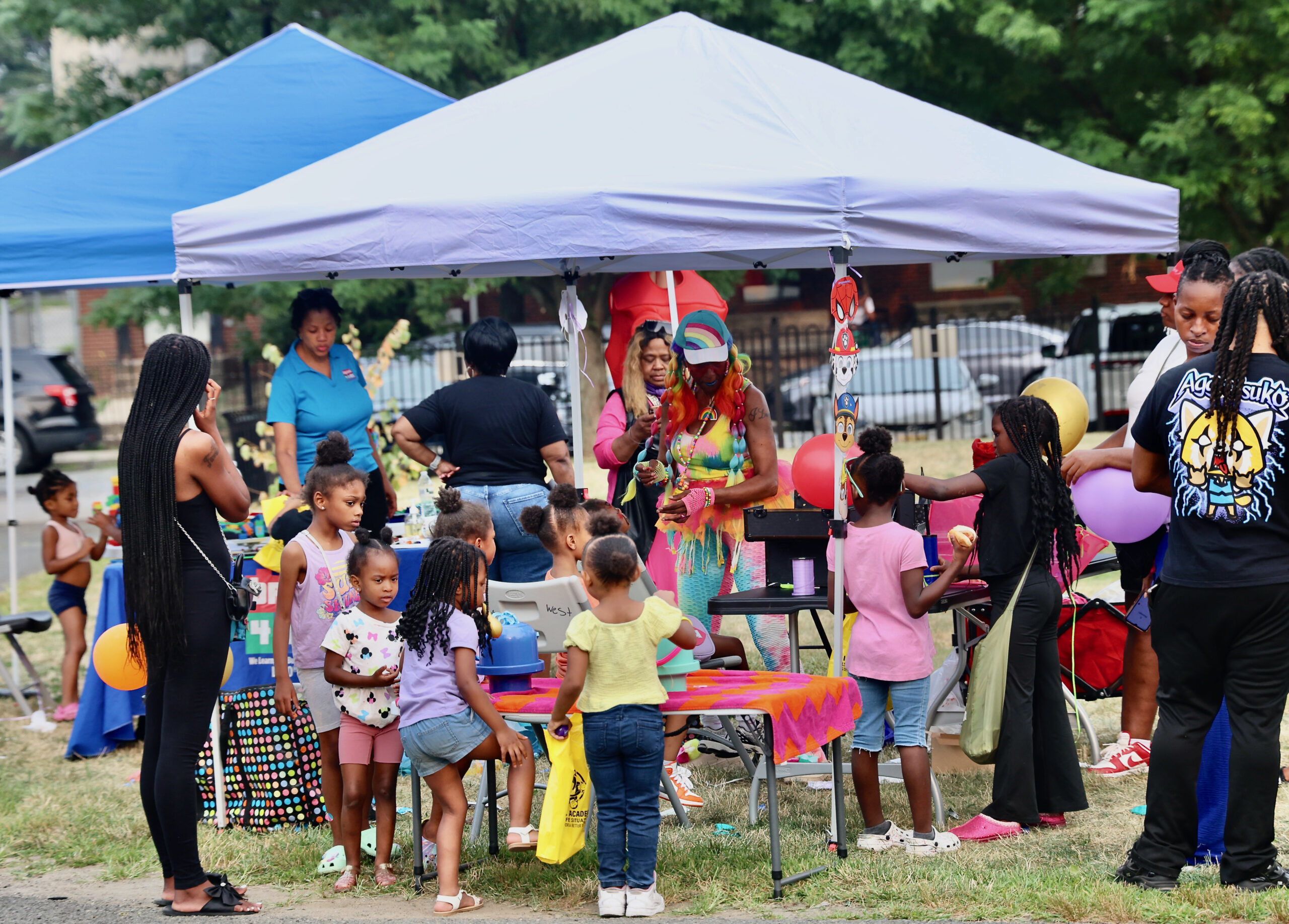 Families gathered under an activity tent during National Night Out at Nat Turner Park