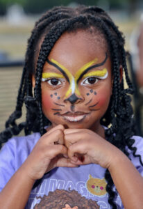 Child with face paint during National Night Out at Nat Turner Park
