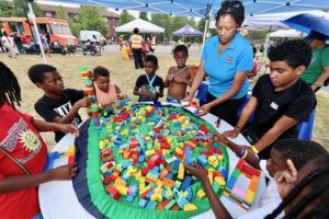 Children building with large blocks during National Night Out at Nat Turner Park