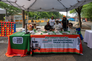 National Night Out outreach table set up near a playground in a Newark park.