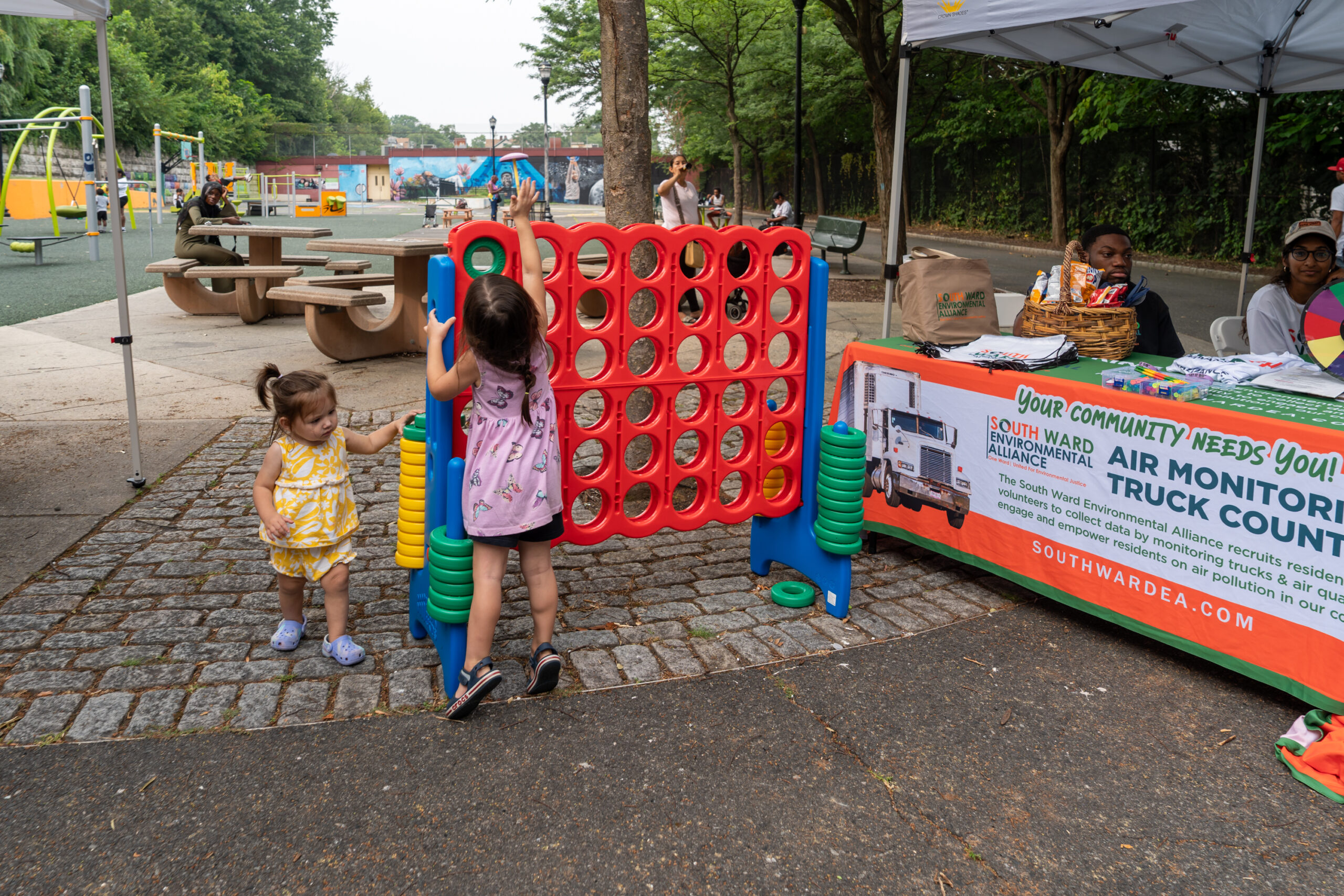 Children playing an oversized Connect Four game during National Night Out at a park.