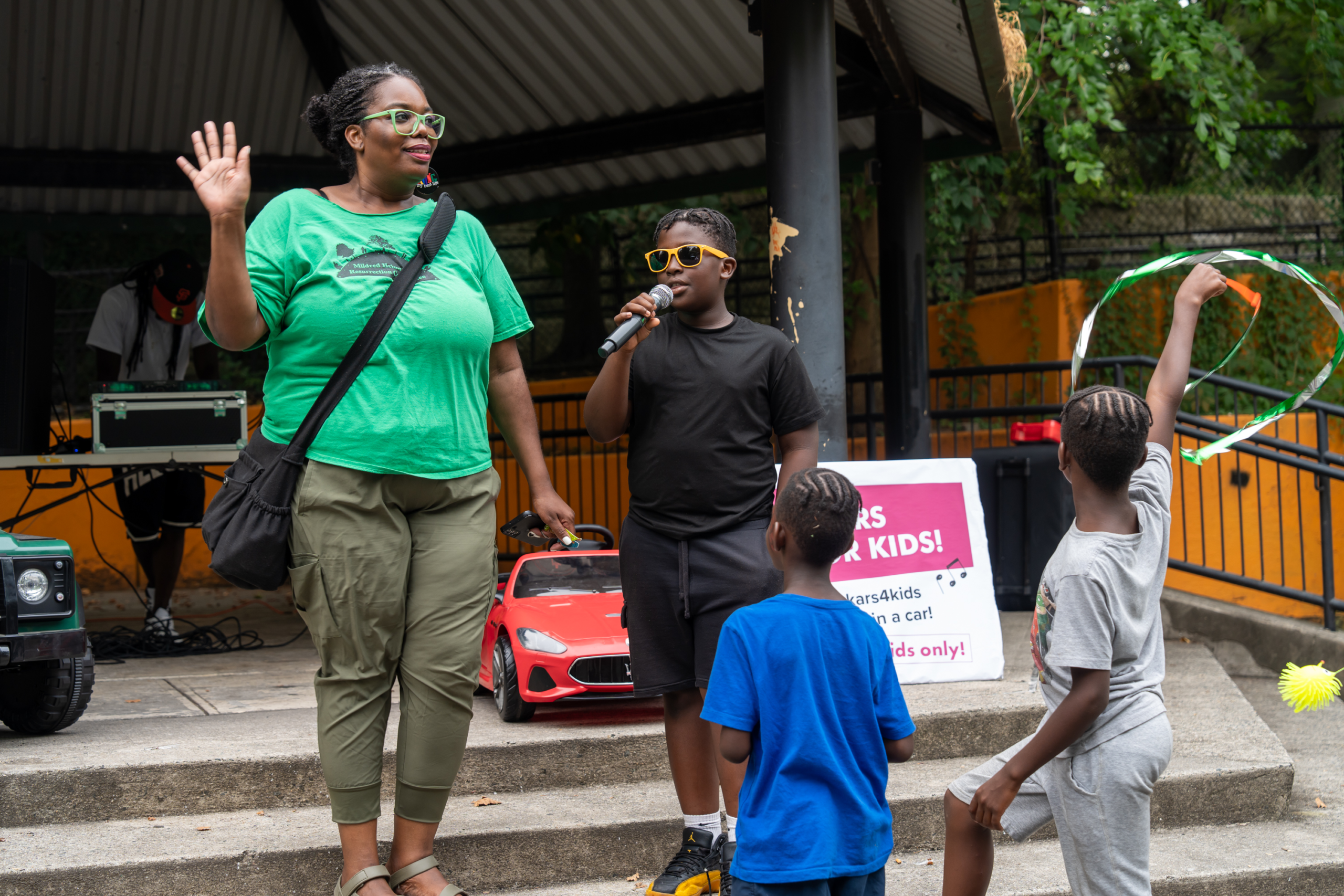 Youth speaking into a microphone during a National Night Out activity.