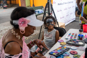 Child getting face paint during National Night Out community event