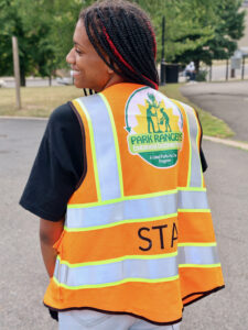 Park Rangers Environmental Enrichment Program staff member wearing a safety vest at a Newark park event