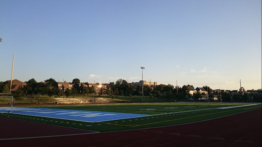 Jesse Allen Park football field and running track during sunset in Newark