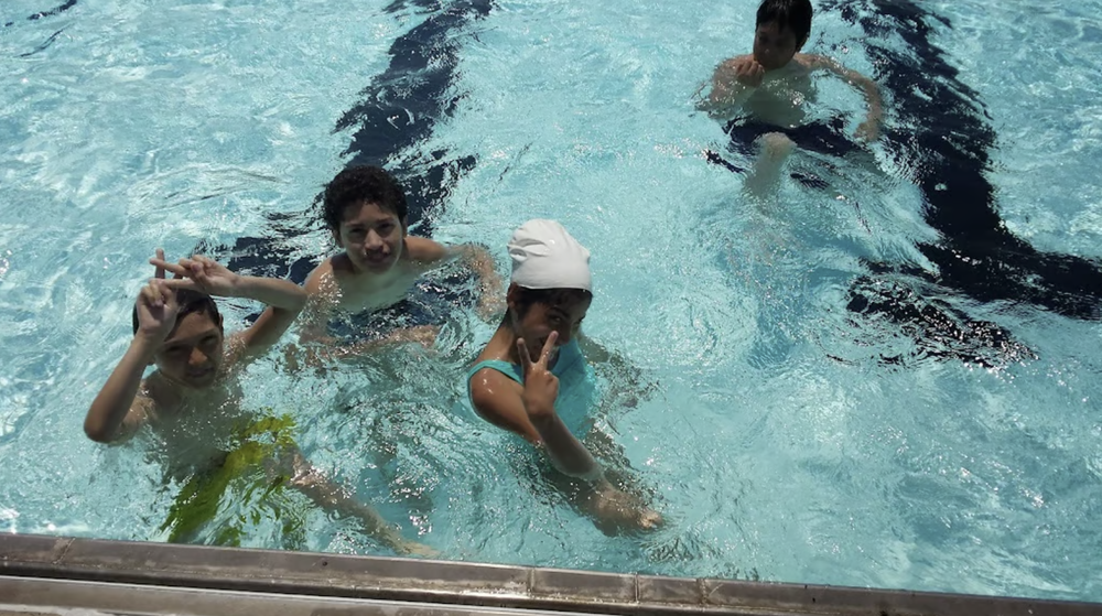 Children swimming in the outdoor pool at Jesse Allen Park