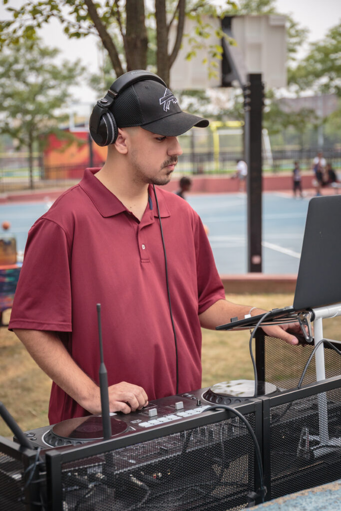 DJ providing music during a community event at Jesse Allen Park