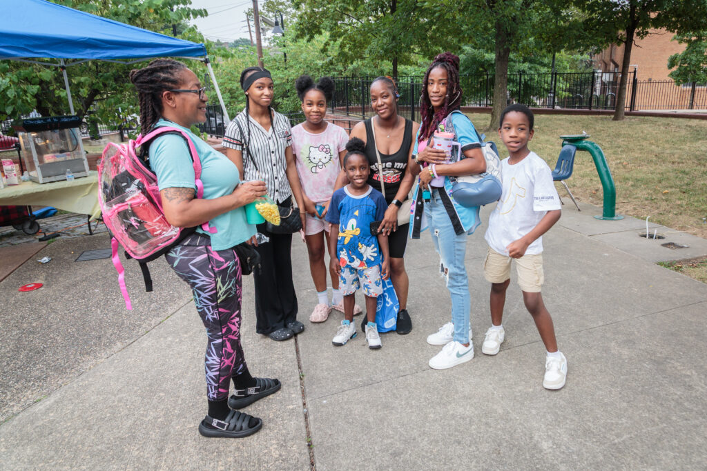 Families posing together during a community event at Jesse Allen Park